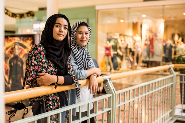 Two people stood in a shopping mall