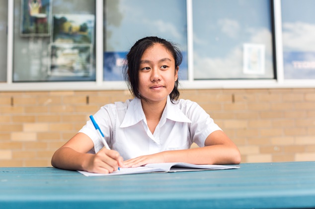 Schoolchild sat with exercise book