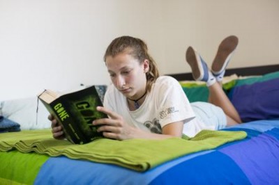 Person reading a book in bed